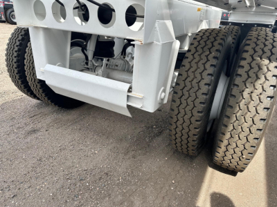 Ranco air ride bottom dump trailer showing dual rear axles and frame components with tire tread details.