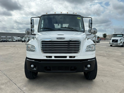 Front view of a white 2018 Freightliner M2106 rollback truck showing grille, bumper, and headlights.