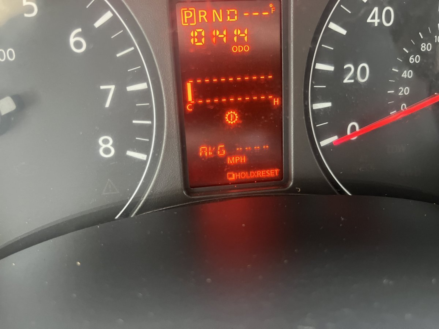 Dashboard of a 2019 Nissan NV Cargo showing gear indicator P R N D with odometer reading 1041 miles and digital display.