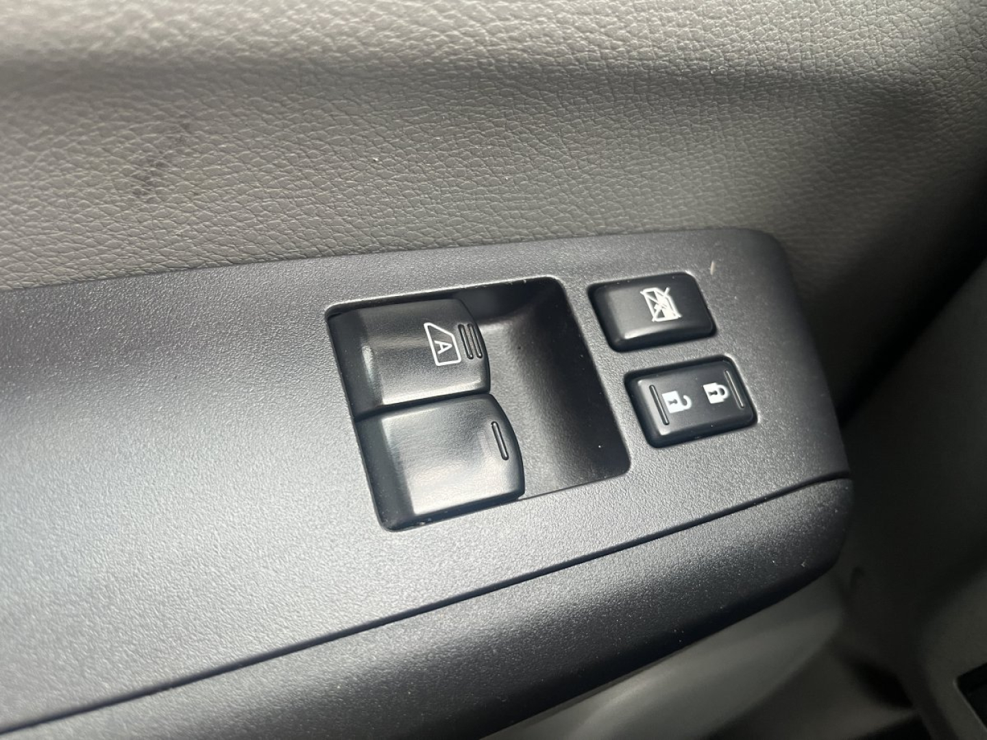 NV Cargo interior showing power window controls and window lock switch on door panel.