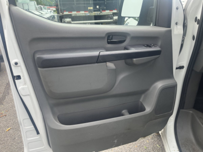 Interior view of a 2019 Nissan NV Cargo door panel showing power window controls, door handle, and storage pocket.