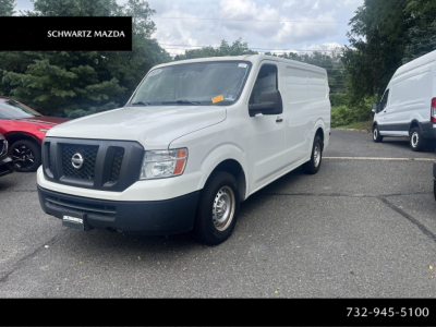 Nissan NV Cargo van in white, front three-quarter view, no cargo, parked on lot; Schwarz Mazda branding visible.