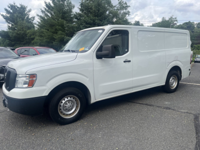 White 2019 Nissan NV Cargo van from a side-front view showing cargo van body with black grille and wheels.
