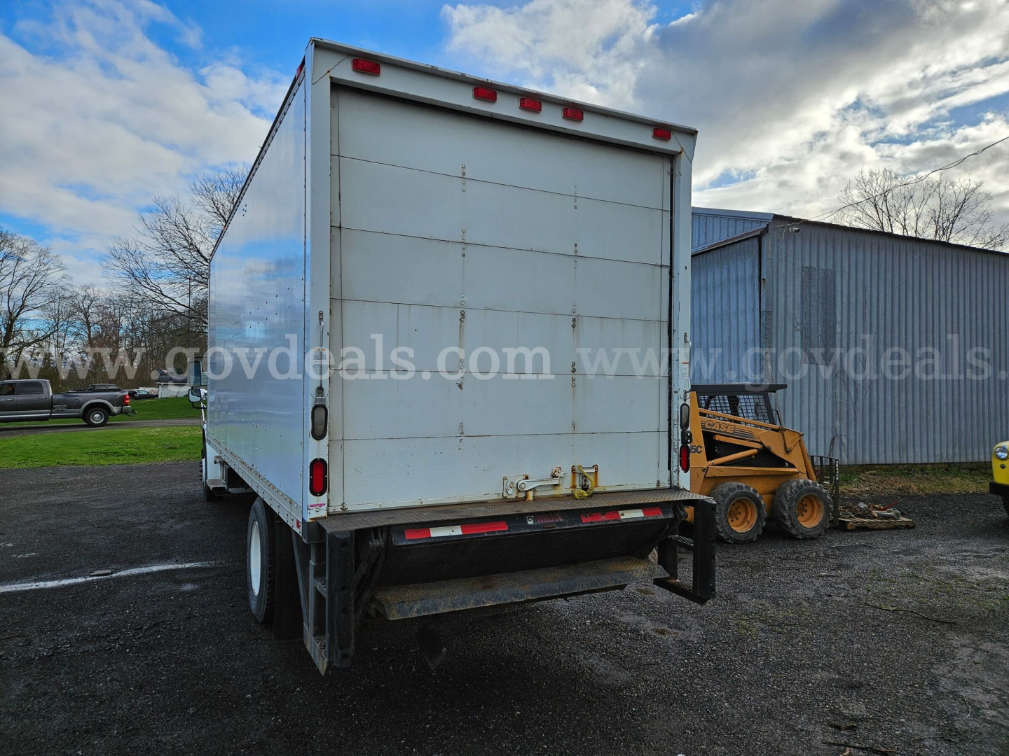 Freightliner M2 106 box truck rear view showing back doors and bumper with red taillights.