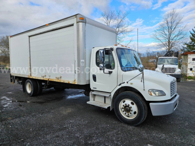 Freightliner M2 106 box truck showing side view with cargo box and cab, VIN plate not visible.