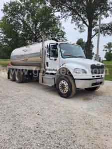 Fuel tanker truck from Freightliner M2 series showing polished aluminum tank and front cab with Stock Number 5111-13.