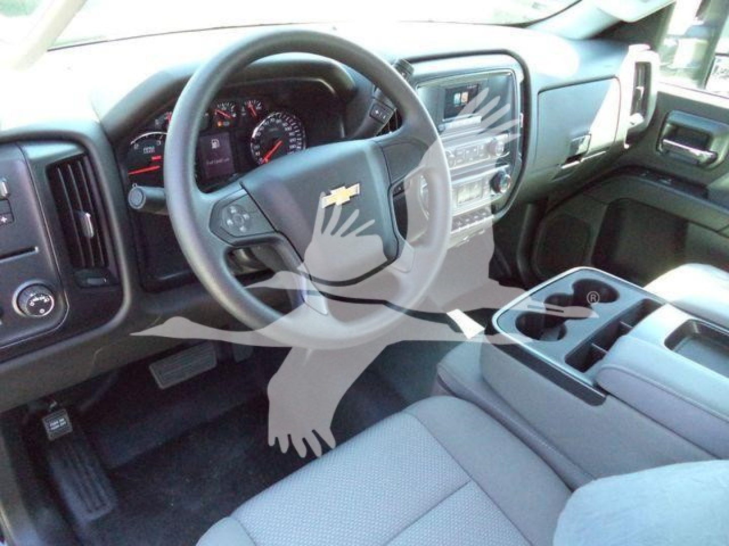 Dashboard and steering wheel of a 2023 Chevrolet Silverado 6500HD interior showing center console, touchscreen, and steering wheel with Chevrolet emblem.