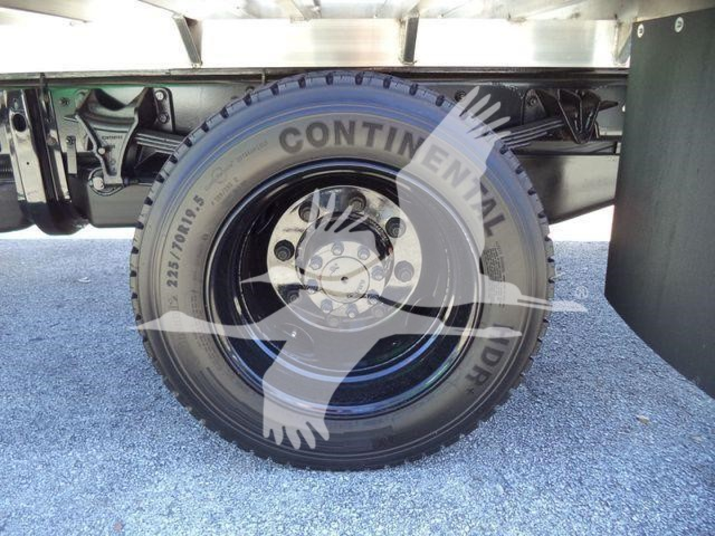 Continental tire mounted on Silverado 6500HD flatbed chassis showing wheel and undercarriage components.