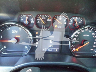 Dashboard view of a Chevrolet Silverado 6500HD flatbed truck showing tachometer, speedometer, and gear indicator with P R N D L, 16 miles to empty.