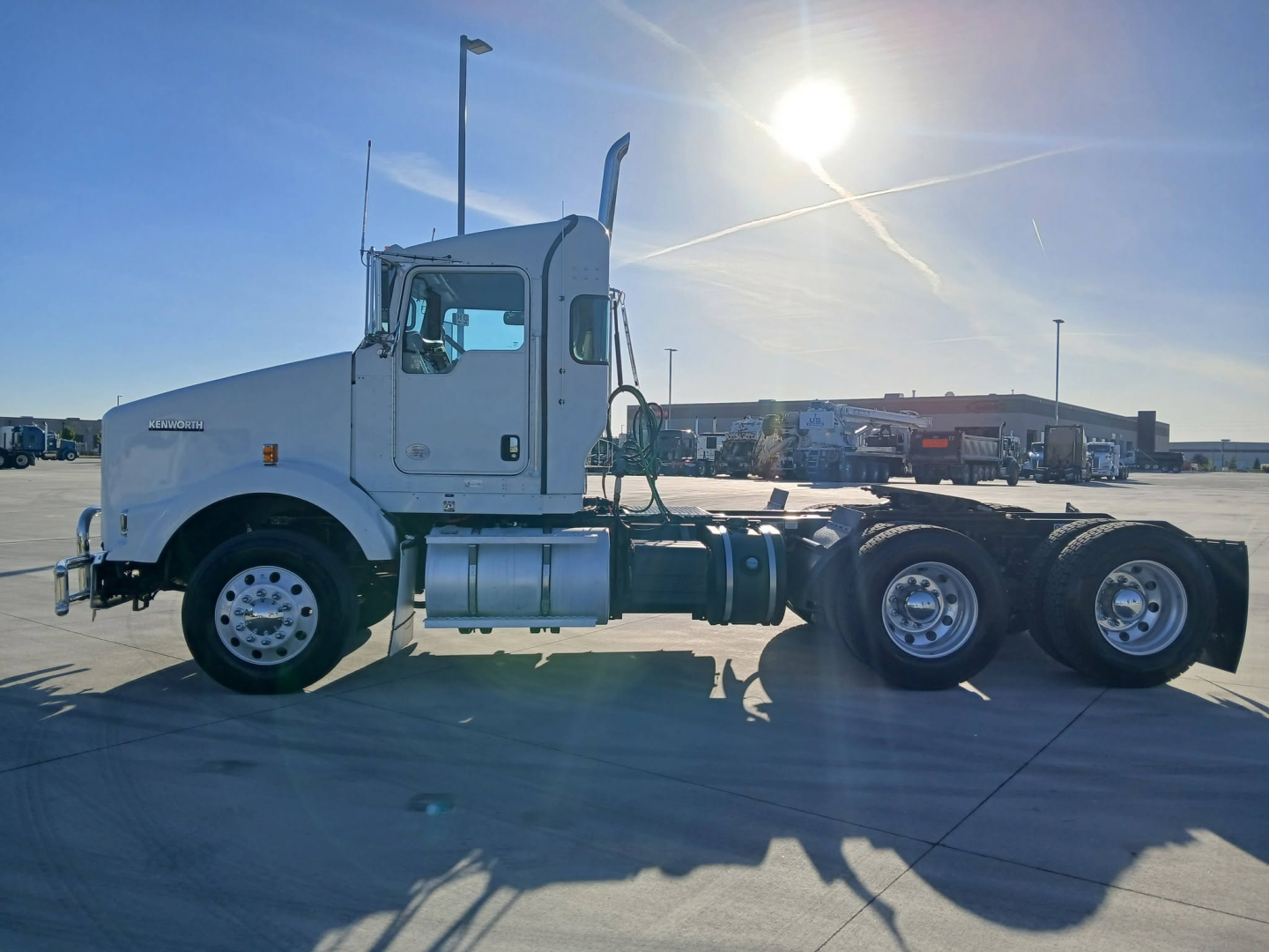 2020 Kenworth T800 tractor side view showing cab, fuel tanks, and dual rear axles. Visible stickers and components include the Kenworth badge on the sleeper, fuel tanks, and wheel rims.