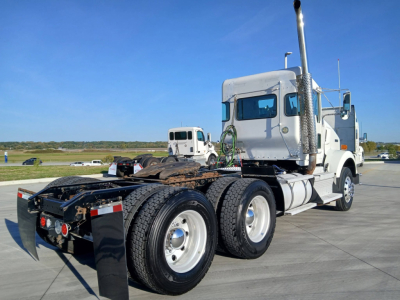 Kenworth T800 tractor in-service with sleeper cab, rear view showing dual rear axles and side exhaust, no visible text in close-up.