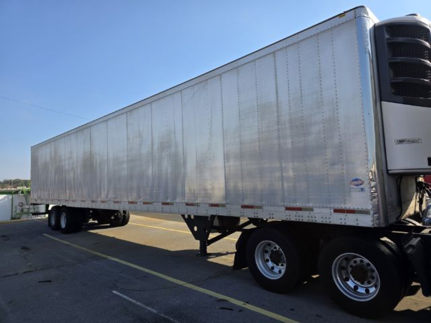 Trailer showing a long aluminum box with tandem axles and a refrigeration unit at the front, 2005 Utility 3000R reefer trailer.