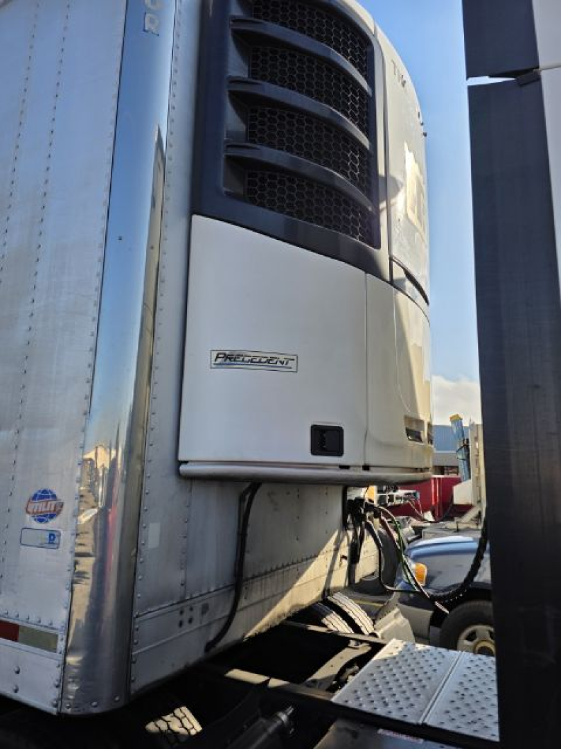 Trailer front view showing reefer unit and Procon? label on white panel of 2005 Utility 3000R trailer.