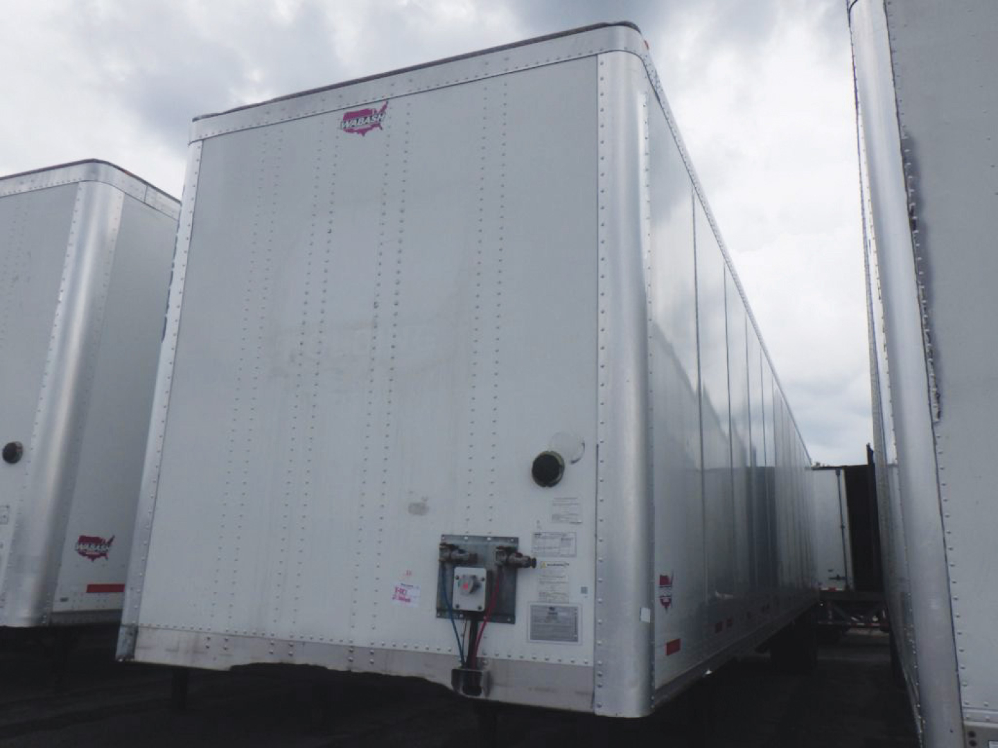 Rear-left view of a white 2021 Wabash DuraPlate dry van trailer showing doors and reflected side panels.