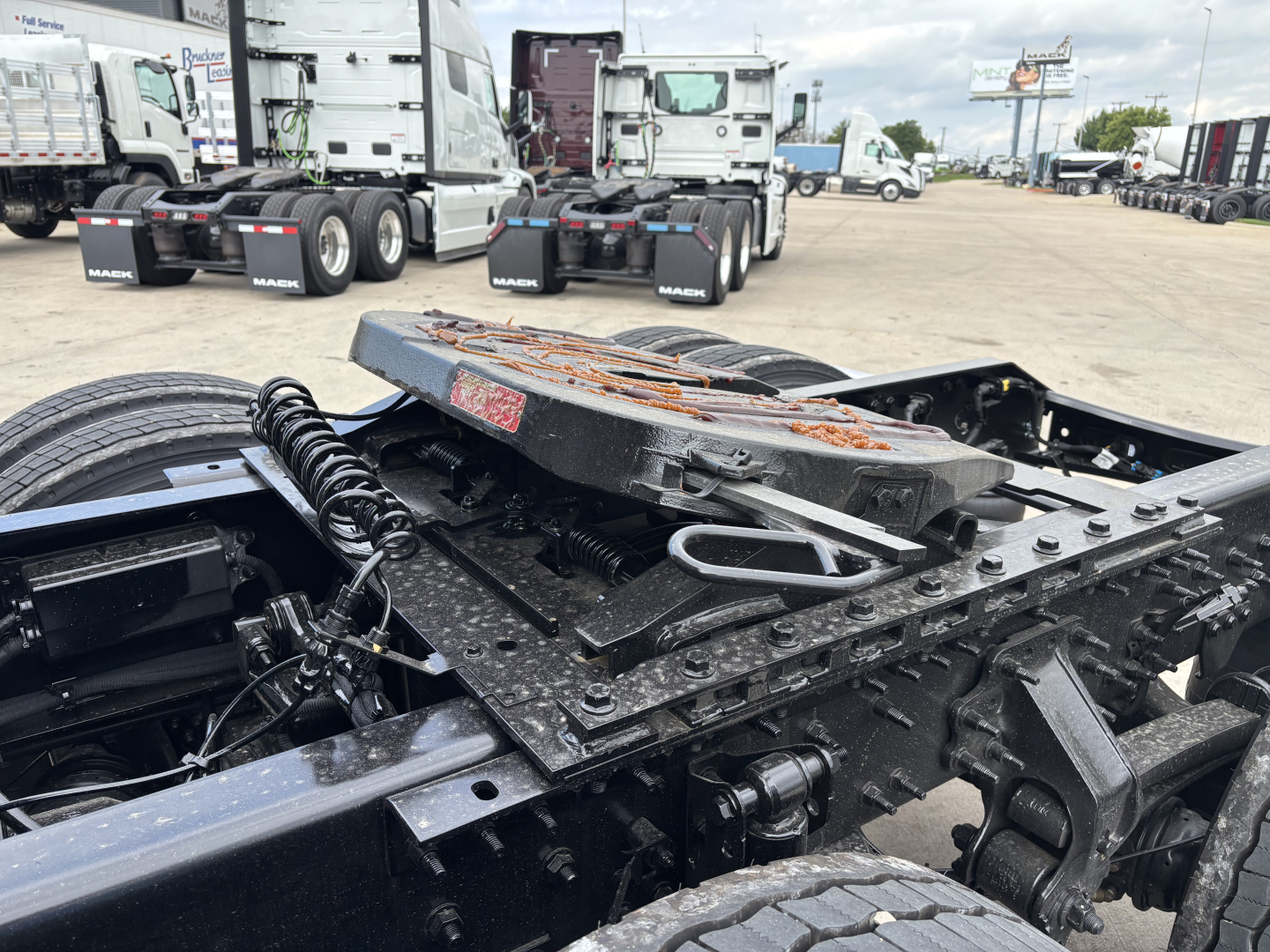 Volvo VNL86 tractor chassis and fifth wheel area showing mounting hardware and frame rails.
