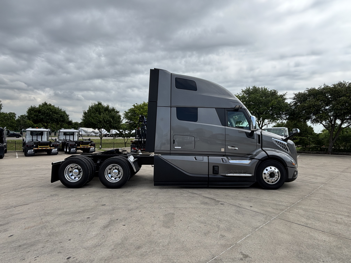 Semi truck tractor in profile view showing 2027 Volvo VNL64T860 with sleeper cab and dual rear axles.