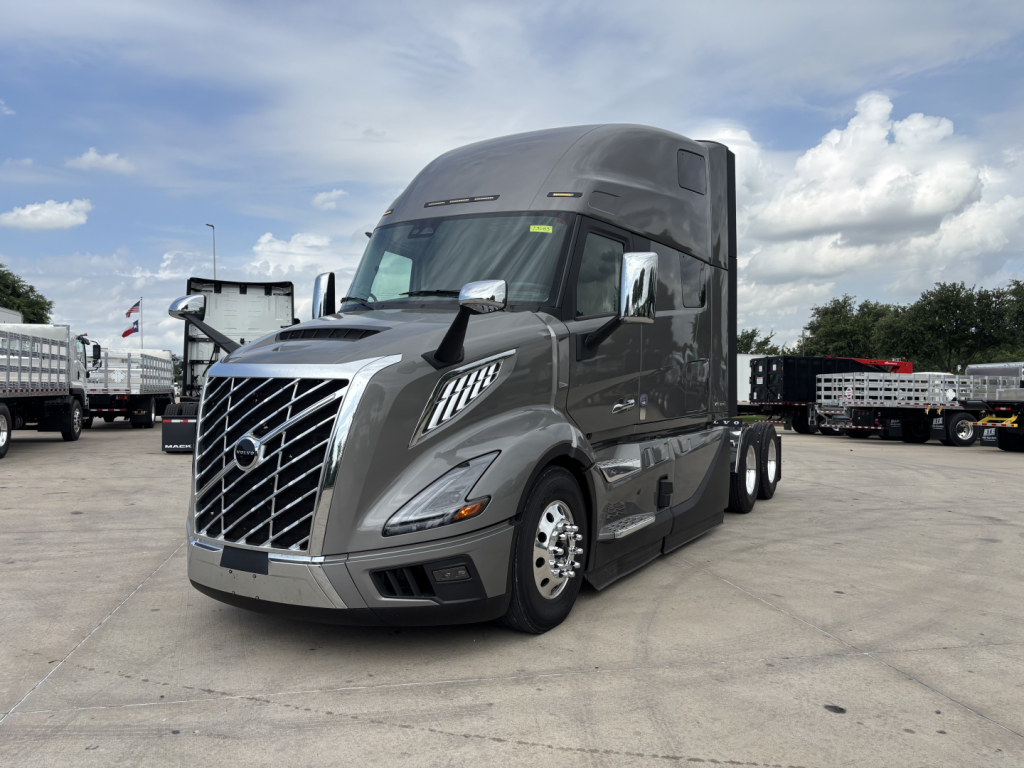 2027 Volvo VNL64T860 semi-truck in a dealership lot, front-left view showing the Volvo emblem grille and aerodynamic cab.