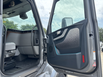 Volvo VNL64T860 cab door open showing interior of truck with black paneling and blue accent line.