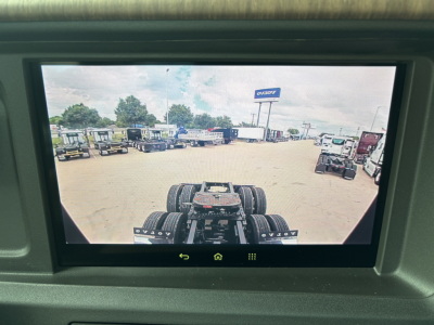 Volvo VNL64T860 cab view on a dealership lot with multiple trucks in background.