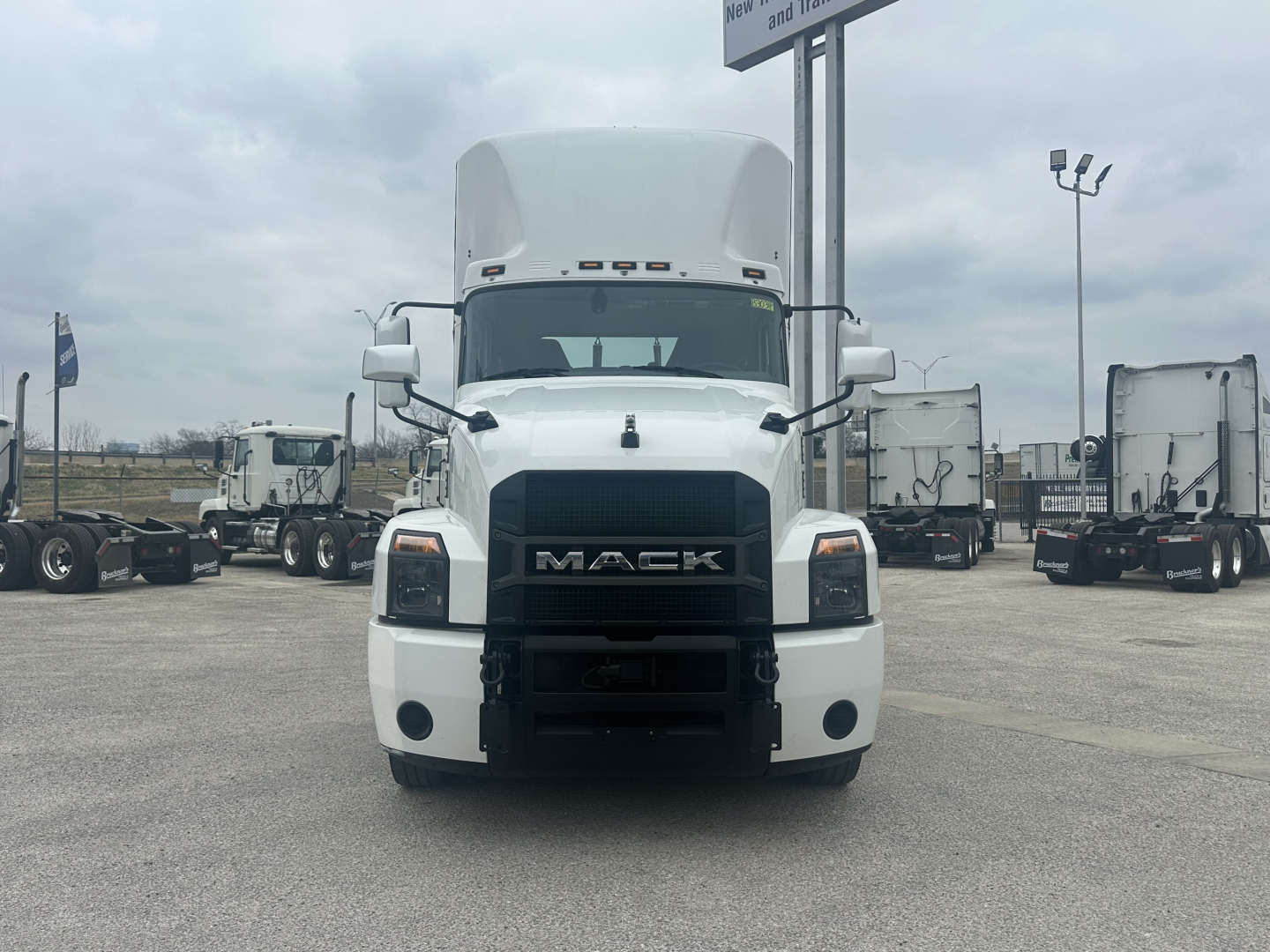 Front view of a white 2022 Mack AN42T truck showing grille with MACK badge, large bumper, and side mirrors.