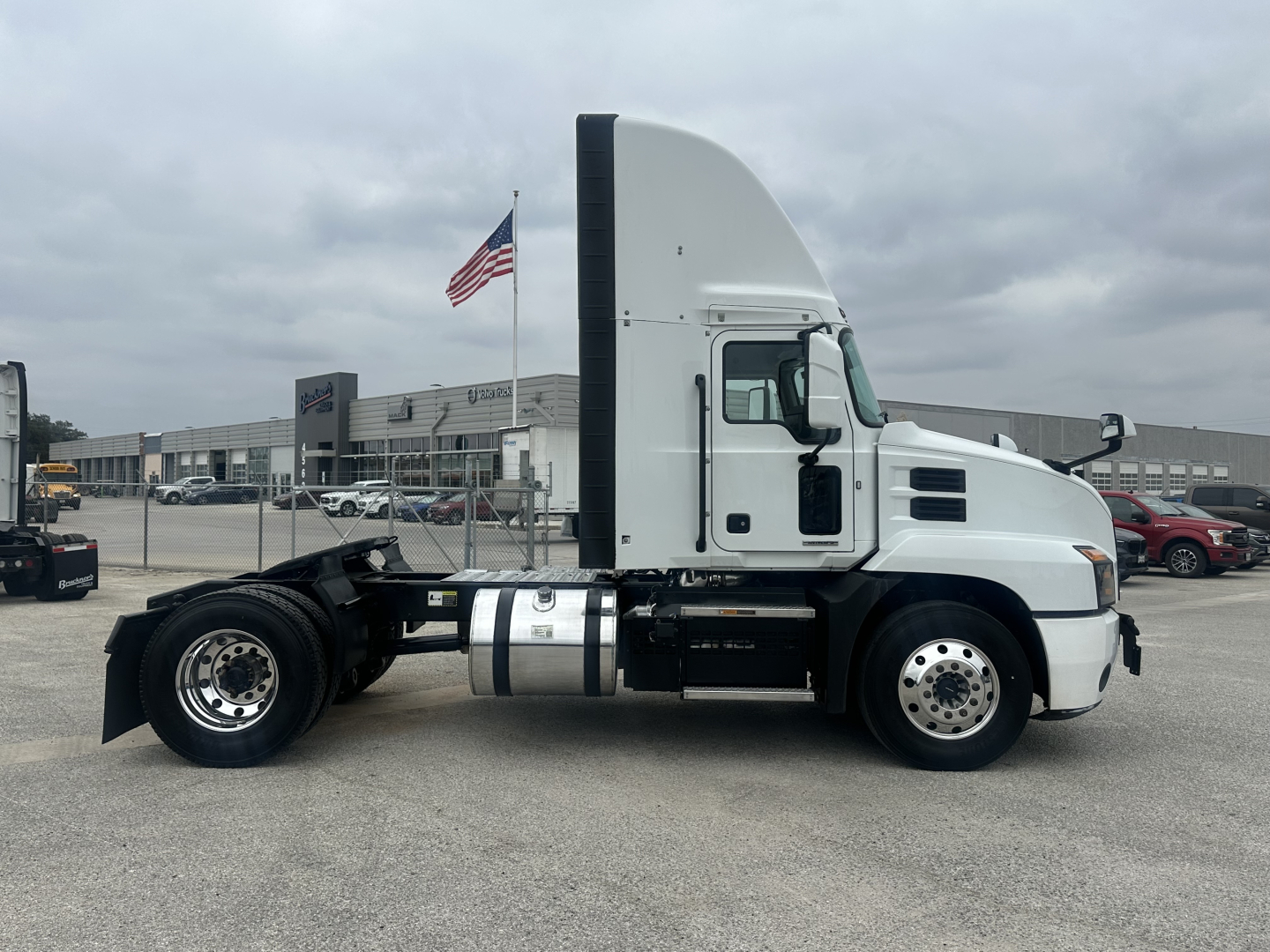 Mack AN42T conventional daycab tractor side view showing fuel tanks and exhaust stack.