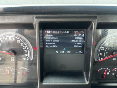Dashboard display showing vehicle totals and digital readout on a Mack AN42T cab; gauges visible on left and right.