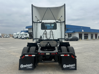 Rear view of a white 2022 Mack AN42T daycab truck chassis showing fifth wheel, rear lights, and mud flaps with Bruckner's branding.