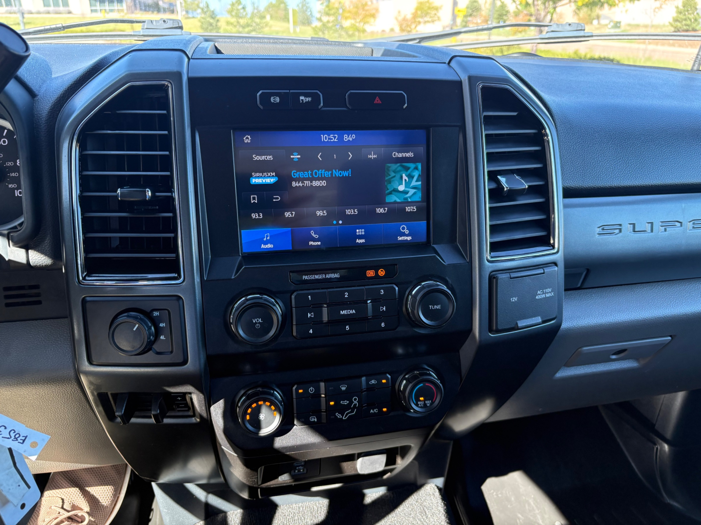 Ford F-550 dashboard with center touchscreen display, climate controls, and multimedia interface visible.