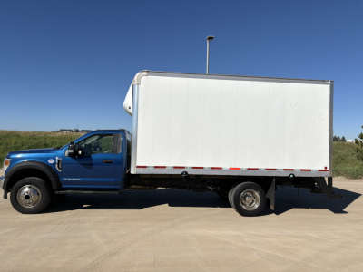Ford F-550 box truck side view showing cargo box and cab with blue color.