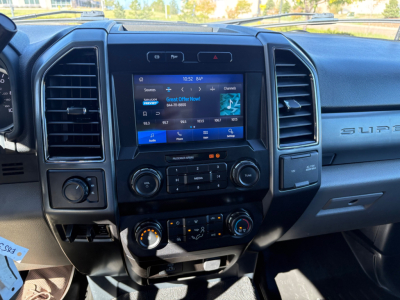Ford F-550 dashboard with center touchscreen display, climate controls, and multimedia interface visible.