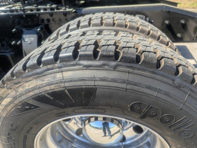 Tire and wheel assembly of a Freightliner Cascadia 126 chassis showing Goodyear tire and polished rim, part of a sleeper tractor.