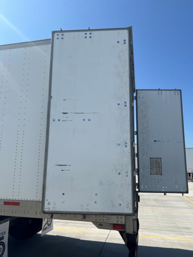 Truck trailer side and rear doors showing a white enclosed cargo trailer with double rear doors and riveted metal panels.