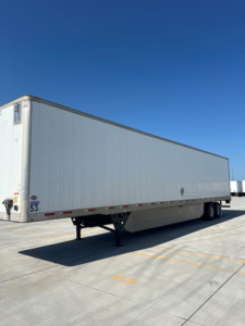 Utility van trailer showing side profile and landing gear with VIN 1UYVS2538EP818204 visible at left rear.