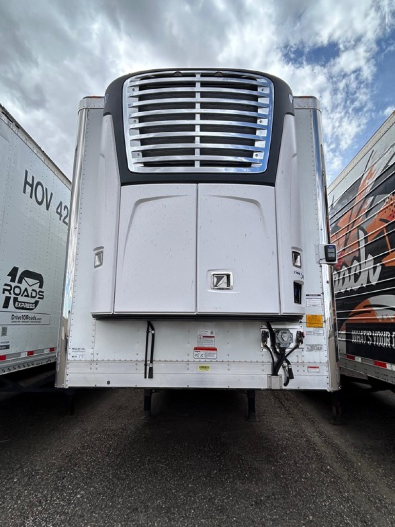 Semi trailer front view showing a large chrome grille and aerodynamic nose of a 2026 Utility 3000R reefer trailer.