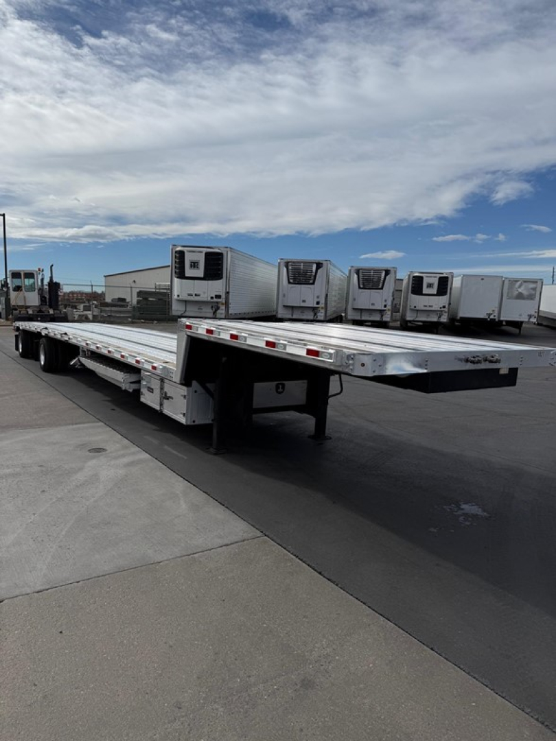 Used 2024 Dorsey combo drop deck trailer showing flatbed with refrigeration units on top and storage boxes underneath, side view in outdoor lot.