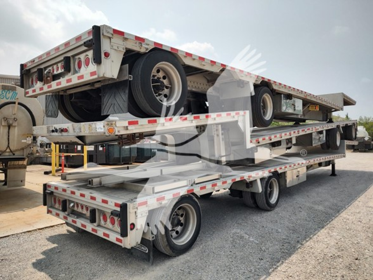 Trailer: 2018 Reitnouer Dropmiser multi-car trailer with three-tier deck and spare tire mounted on top tier; aluminum exterior with red/white reflective tape; dual rear ramps.
