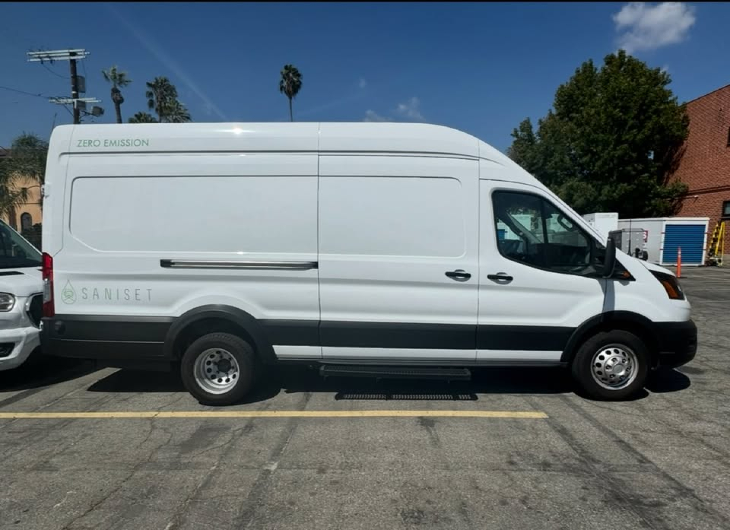 Ford Transit 350 HD high roof cargo van side view showing zero-emission badge and Saniset/Zero Emission label.