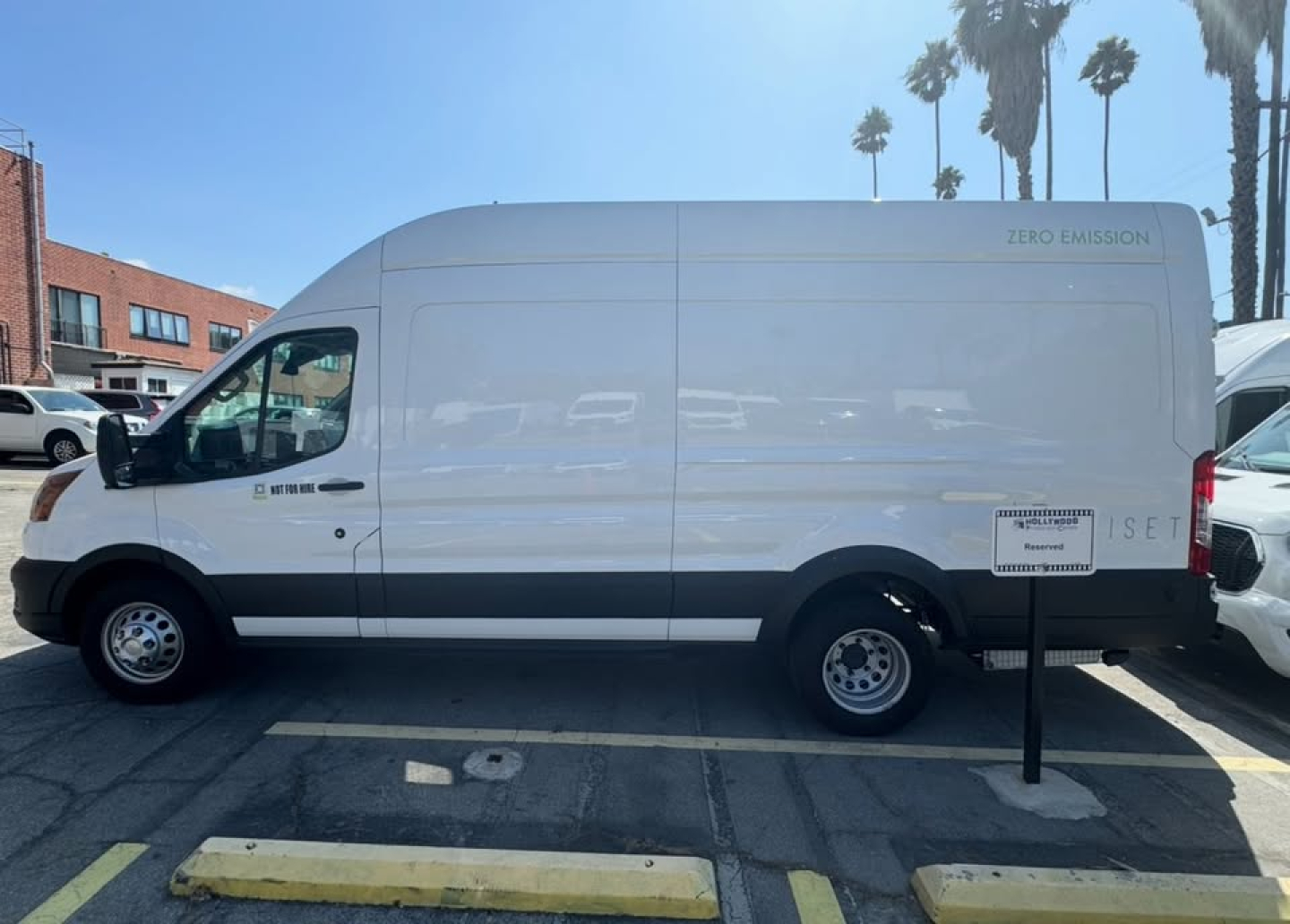 Ford Transit 350 HD cargo van side view showing Zero Emission badge and cargo van lettering on body.