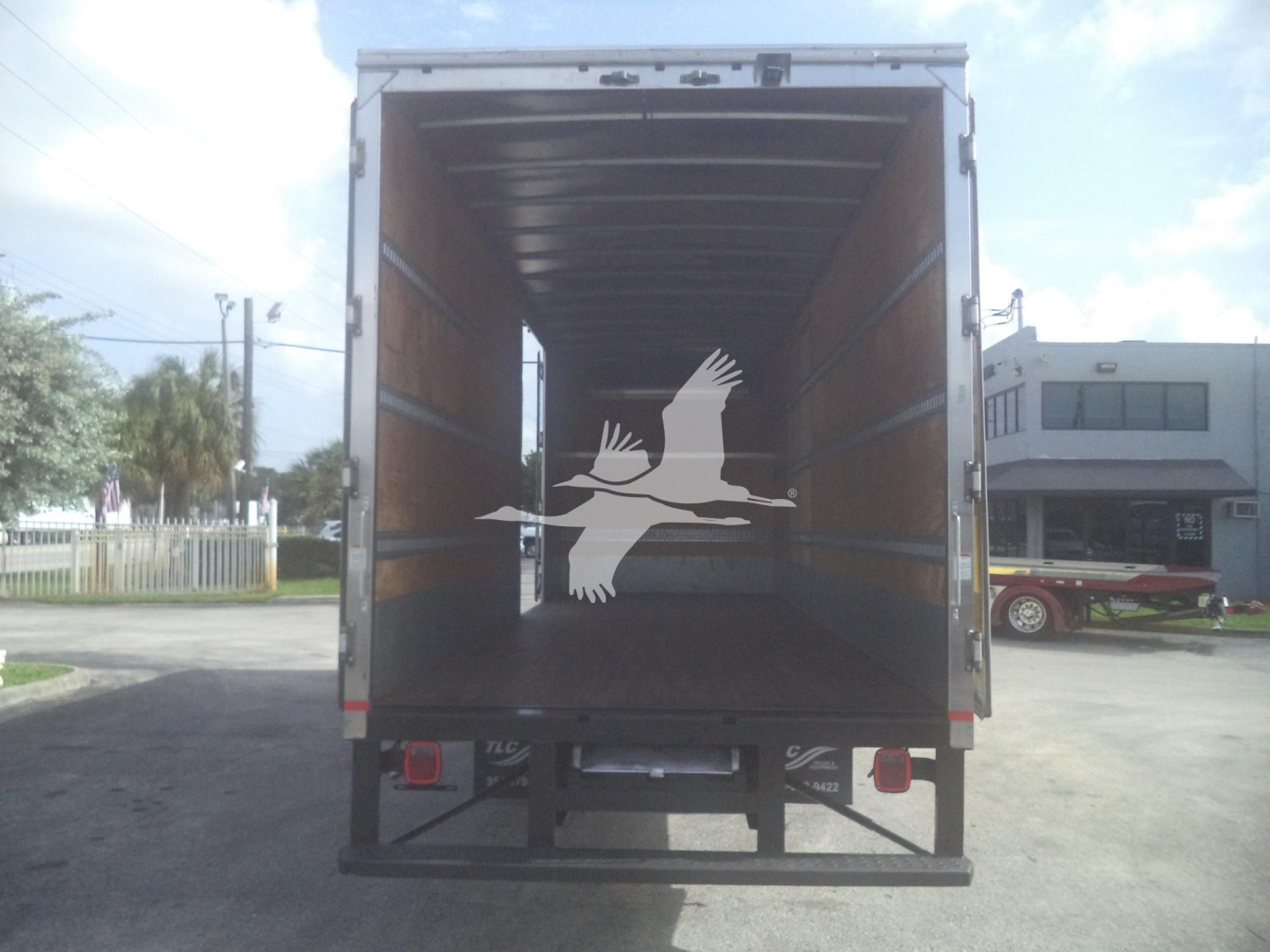 Truck cargo area of a 2020 International MV moving van showing empty interior and rear doors.