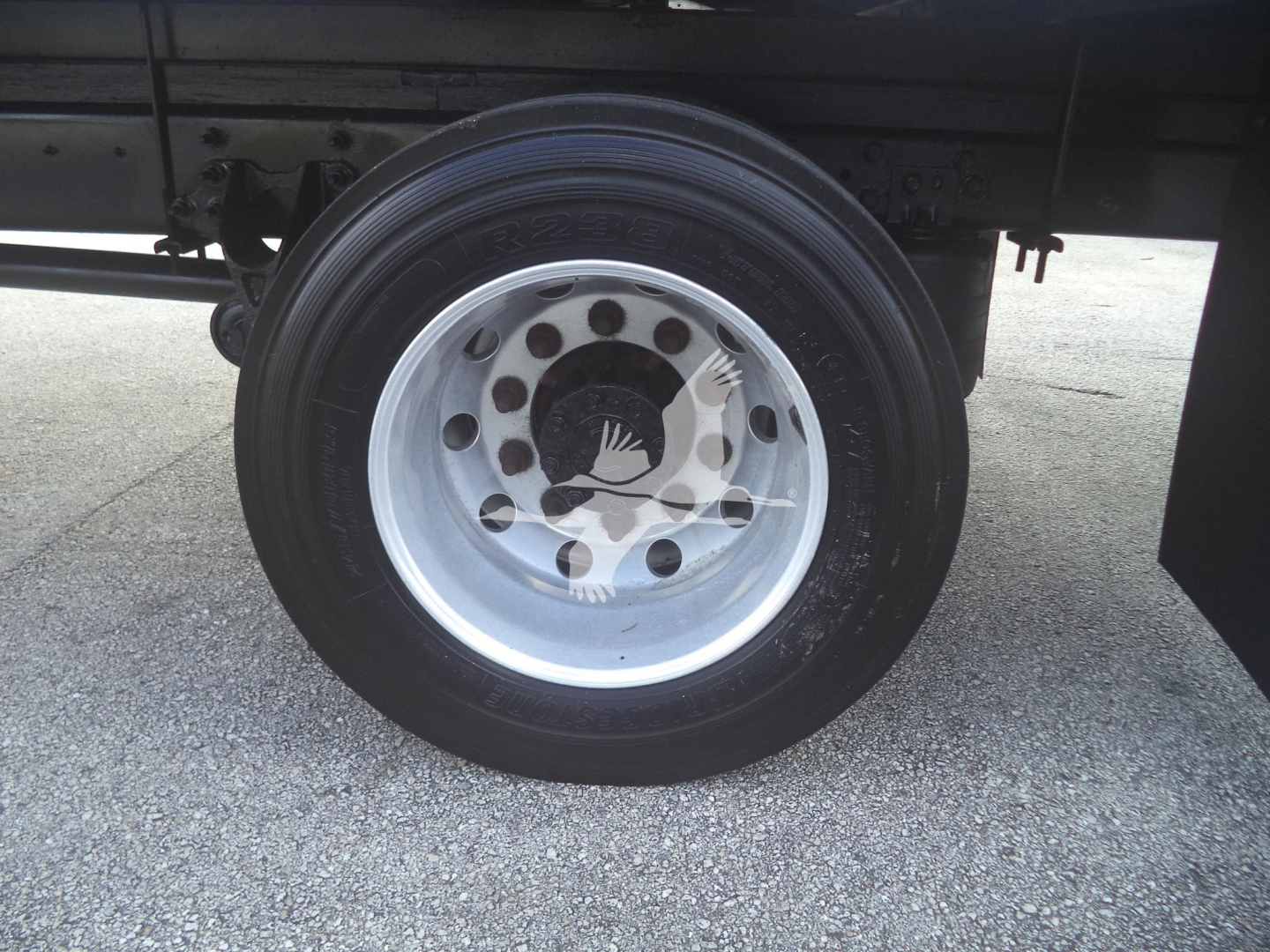 Wheel and tire close-up on a 2020 International MV moving van showing steel wheel with hub, lug nut holes, and tire tread edge.