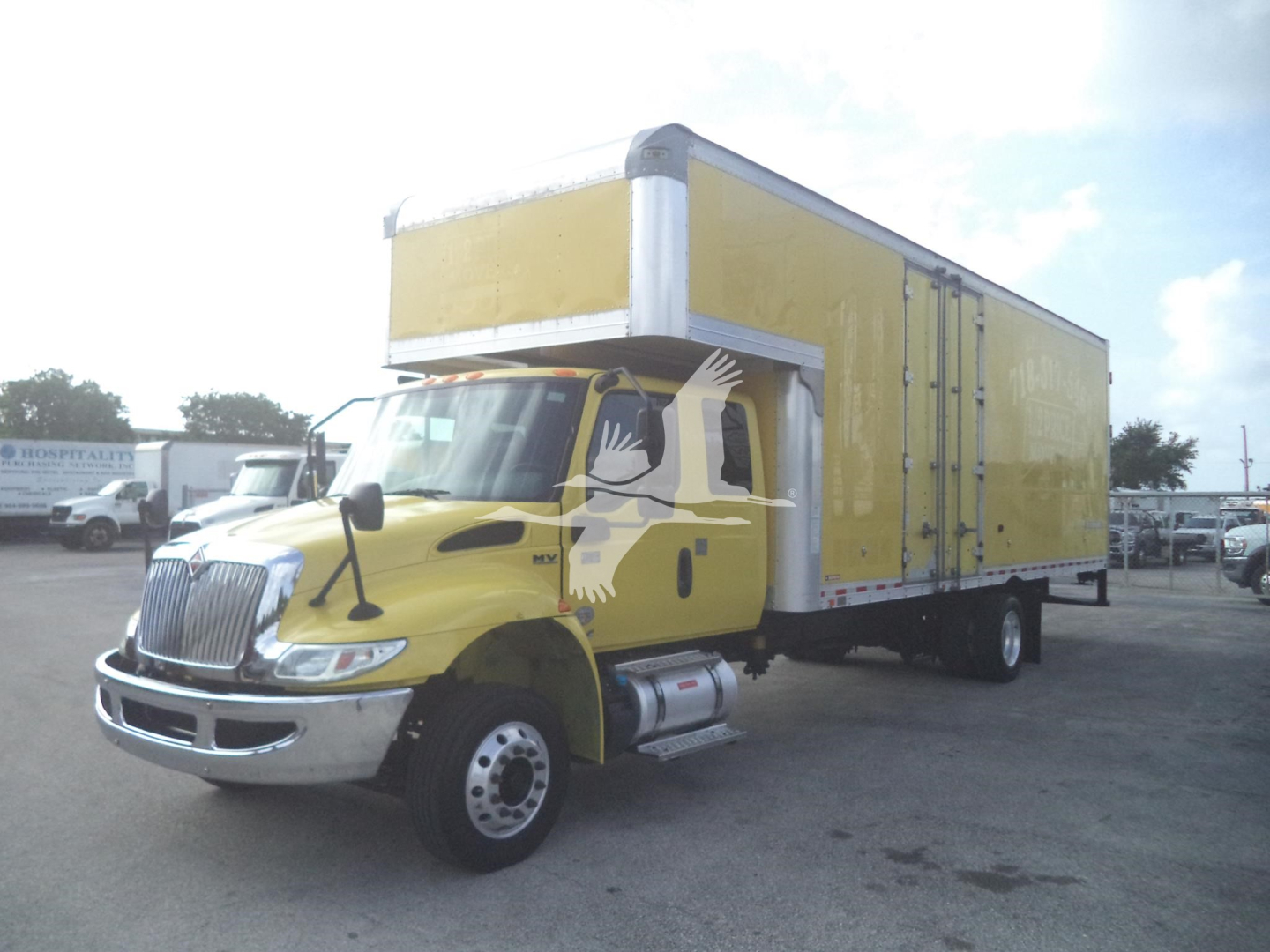 Truck cab in front with yellow moving van box, stock number T94955, VIN 3HAEWMML4LL194955, category moving van, used truck.