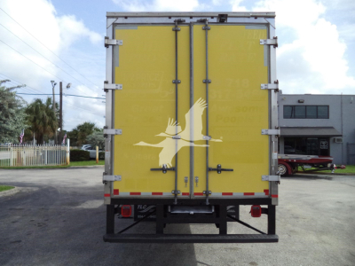 Rear view of a yellow enclosed moving van with double doors and metal latches.