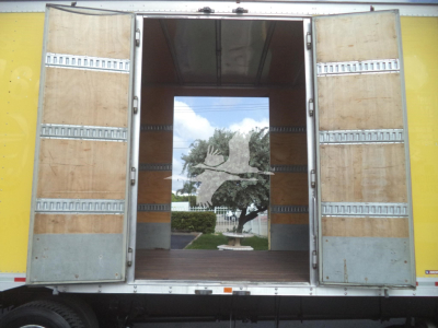 Truck rear doors open to show empty cargo area of a 2020 International MV moving van.