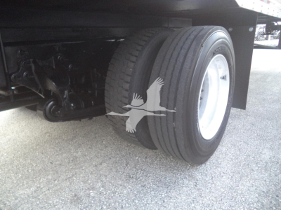 Truck rear dual wheels and chassis showing tire tread and suspension components