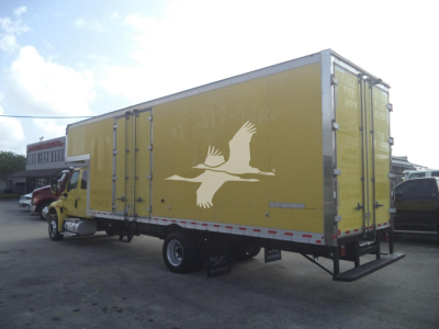 Truck body showing a yellow moving van with a white bird graphic on the side and rear doors closed.