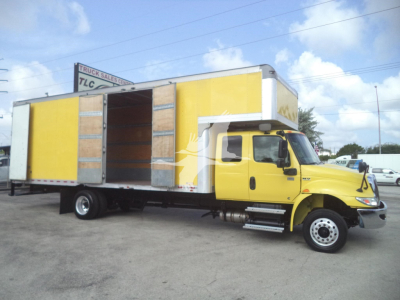 Moving van truck with yellow cab and large yellow box, slide-out doors open on both sides.