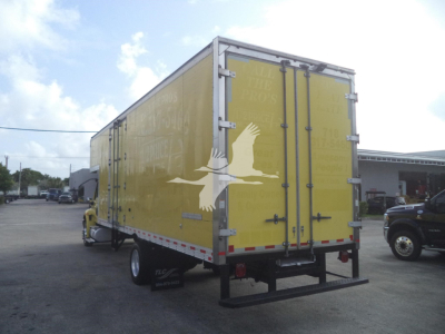 Truck box rear view showing yellow cargo area with silver hinges and doors, black rear bumper, and white bird graphic.