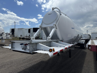 Pneumatic dry bulk trailer by Polar Gravity Drop, 2012 model, mounted on a trailer with cylindrical tank and rear chute, visible VIN/serial numbers 1637 and 1637 on tank, shown in a used equipment lot.