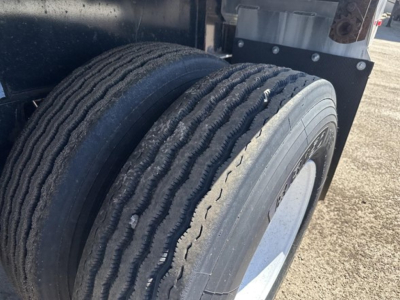 Trailer wheel setup showing dual rear tires of a 2020 Fontaine Infinity flatbed trailer, with rims and tire treads visible.
