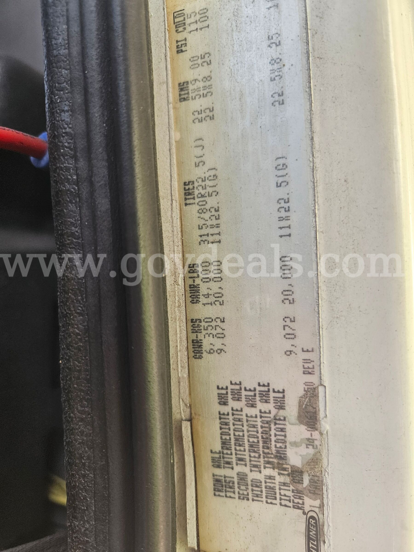 Label showing vehicle specifications and weights on a door jamb of a Freightliner cab. Includes VIN, axle and tire data, weights, and production codes.